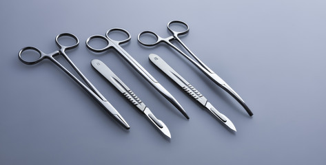 Surgical instruments on a blue-gray background