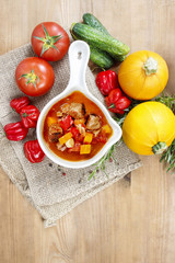 Bowl of goulash soup and fresh vegetables