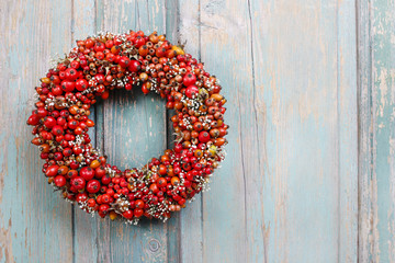 Holiday door wreath with rose hip, hawthorn and rowan berry