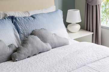 bed and pillows with white lamp