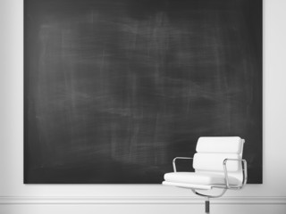 White office chair and blank chalkboard on a wall