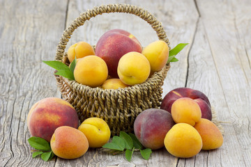 fresh fruits in a basket on wooden background
