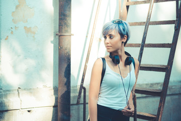 young beautiful short blue hair hipster woman with headphones mu