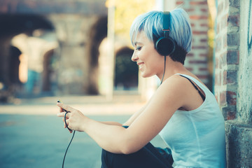 young beautiful short blue hair hipster woman with headphones mu