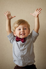 Happy handsome little boy in a bow tie