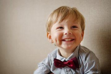 Young Boy Wearing Bow Tie Smiling and Looking Up