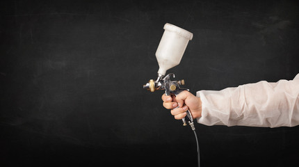 Painter works with airbrush gun and empty copyspace