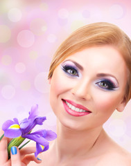 Beautiful young woman with glamour make up and flower ob bright