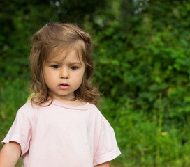 thoughtful little girl  green background