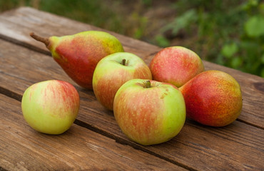 apples and pears on wooden table