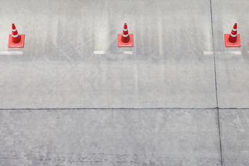 traffic warning cone in row to separate route in parking area