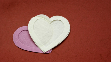 Felt heart frames and shape on paper. Background for Valentine