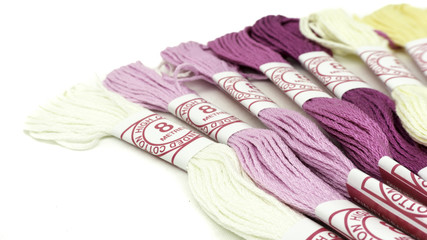 Slightly defocused strands of colourful cotton yarn