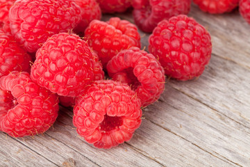 Fresh ripe raspberries on wooden table