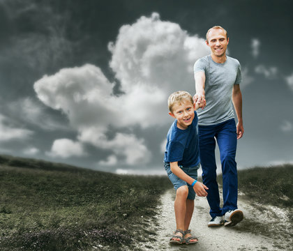 Son with father running on the footpath