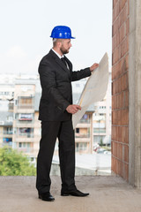 Caucasian Male Construction Manager With Blueprint