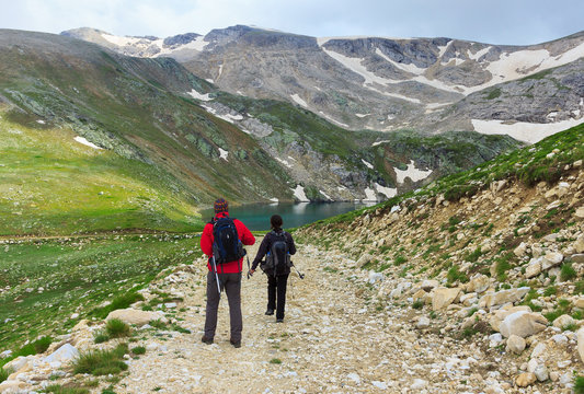 Couple of travelers walking on a trail in Uludag Mountains
