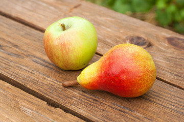 apples and pear on wooden table