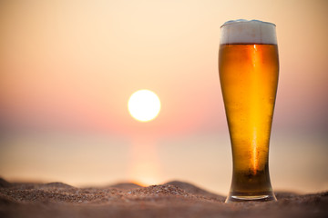 Glass of beer on a sunset