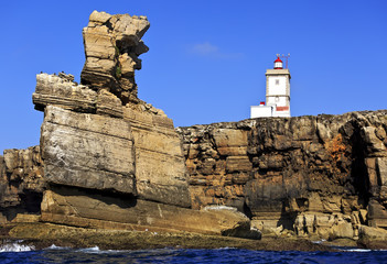 Fototapeta na wymiar Lighthouse at Cape Carvoeiro, Nau dos Corvos. Peniche, Portugal