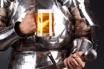 knight wearing armor and holding mug of beer and two-handed swor