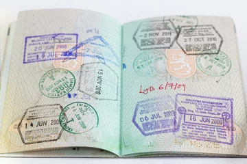 Zelfklevend Fotobehang Closeup of an open passport with many stamps © tuomaslehtinen