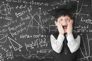 boy near blackboard with formulas