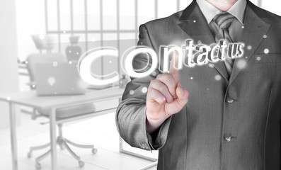 Businessman pushing CONTACT US sign