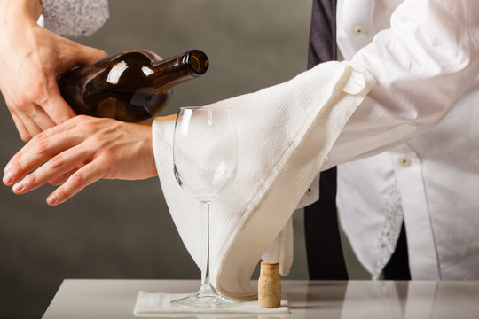 Man Waiter Pouring Wine Into Glass.