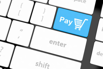 Pay key with shopping cart icon on a white keyboard