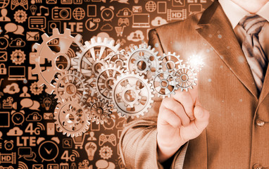 businessman hand touch  gear to success concept