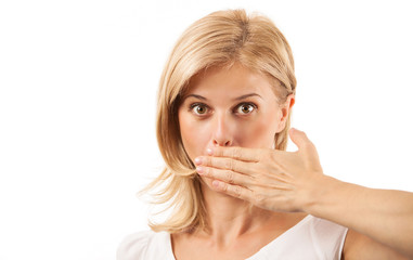 Amazed young woman covering mouth over background