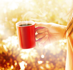 Woman with red cup of coffee vibrant brown background