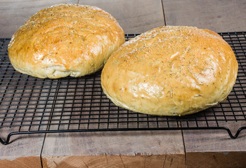 Artisan rosemary bread on cooling rack