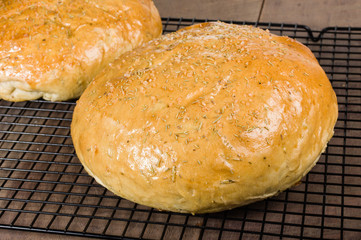 Artisan rosemary bread on cooling rack