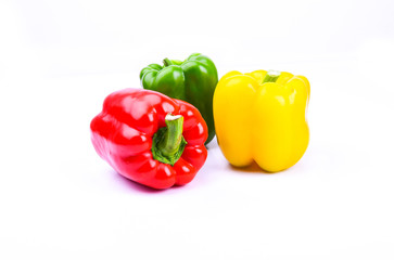 red, green and yellow paprika on a white screen