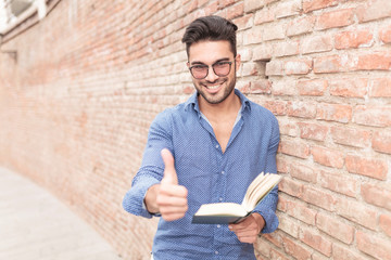 man making the ok sign while reading a book