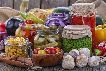 Several kinds of healthy domestic canned vegetables in jars