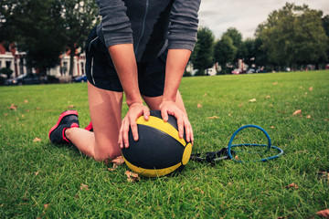 Woman with medicine ball and resistance band