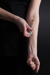 drug addict makes an injection into a vein
