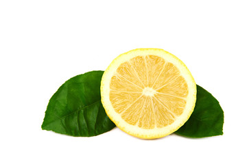 Fresh lemon with green leaves.