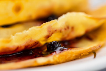 Fresh pancakes on plate. Close up of a homemade crepe with jam f