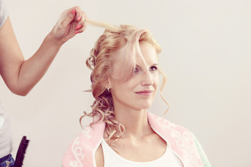 hair stylist designer making hairstyle for woman