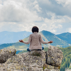 Fototapeta na wymiar Girl in meditation on Dolomiti - Italy