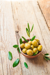 Olives on rustic table in a bowl