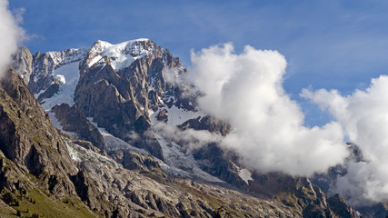 Mountain tops in summer with clouds and trees. Near Chamonix.