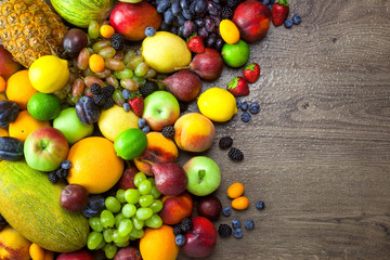 Naklejka na ściany i meble Mix of Fresh Fruits with water drops on dark wooden table