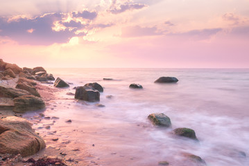 Fototapeta na wymiar Sunrise landscape over beautiful rocky coastline in the Sea