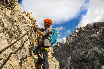 Woman climber on via ferrata Torre di Toblin, Dolomites, Italy