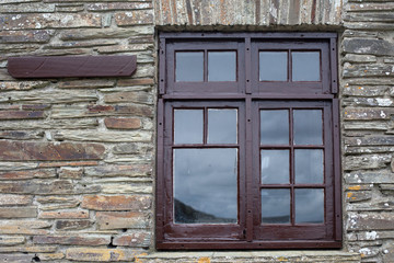 Fototapeta na wymiar Brown window frame on a brick wall